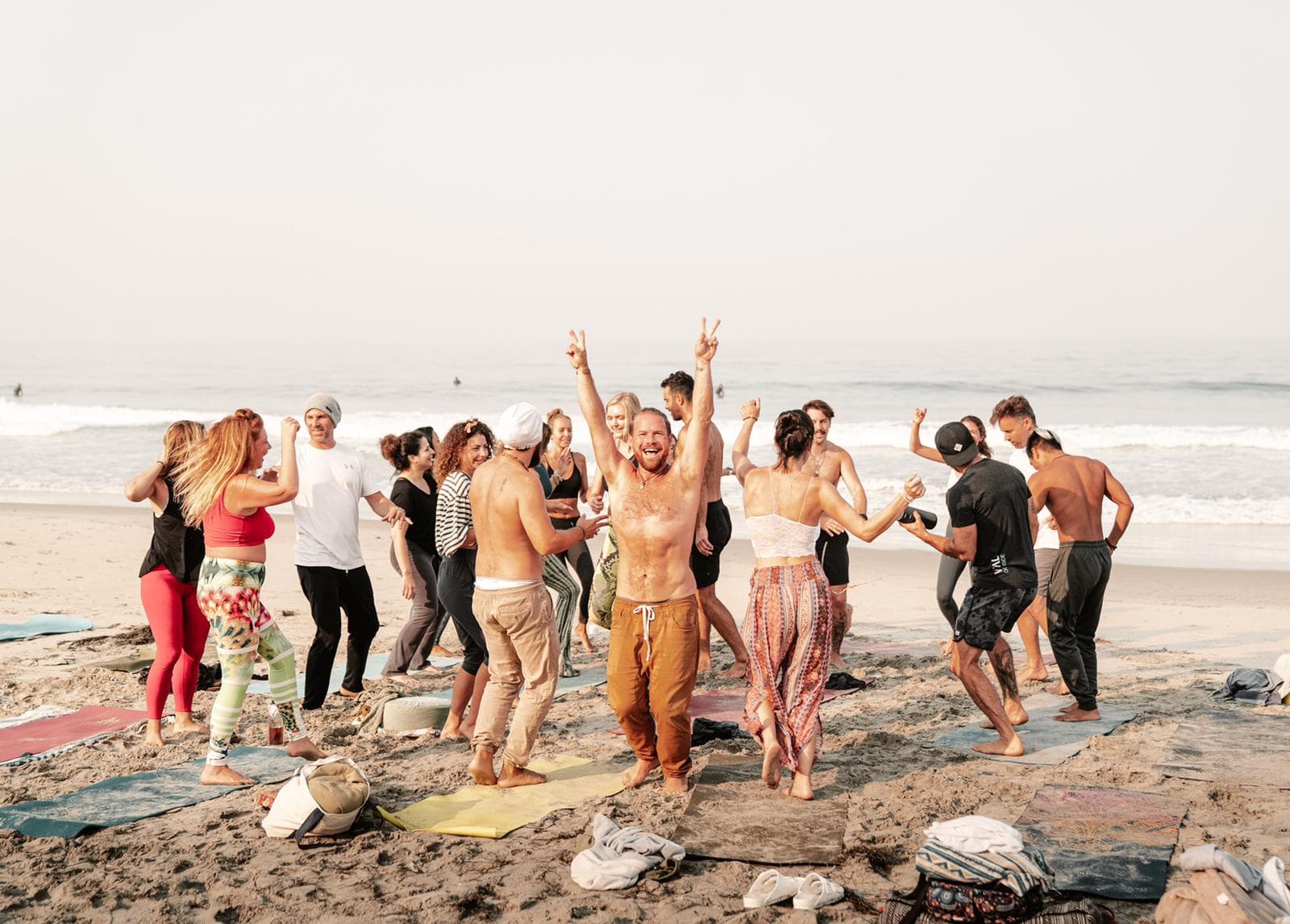 A group of friends gathered together on the beach