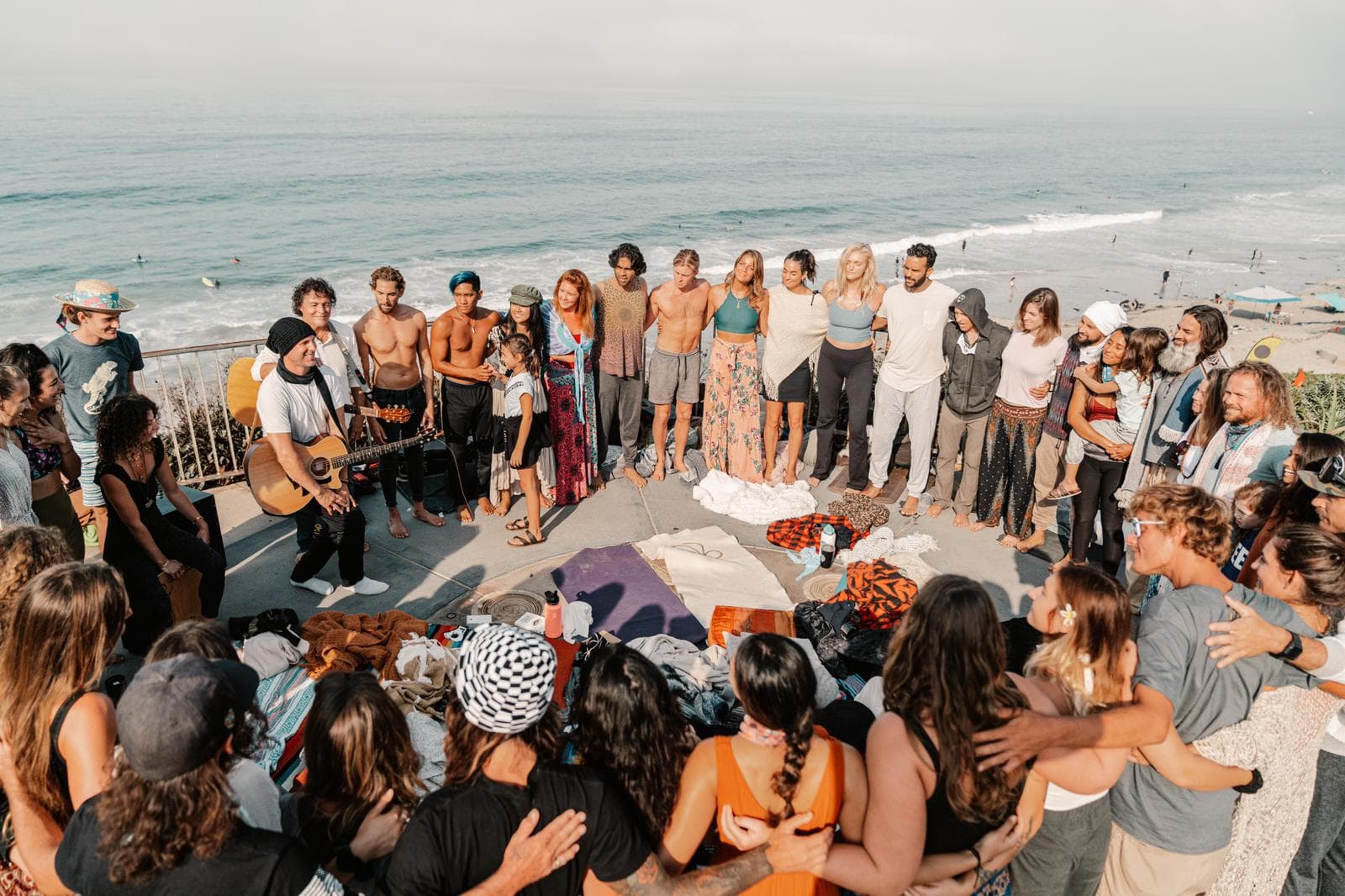 A Frequency music circle gathered on a cliffside at golden hour