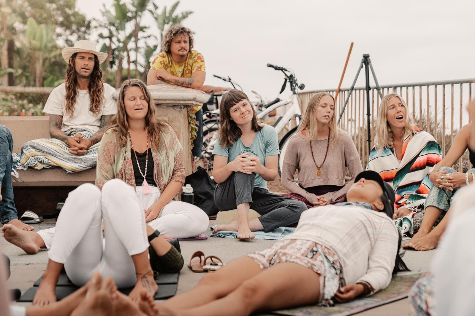 A group of people gathered together singing, lit up and laughing, no drinks in sight