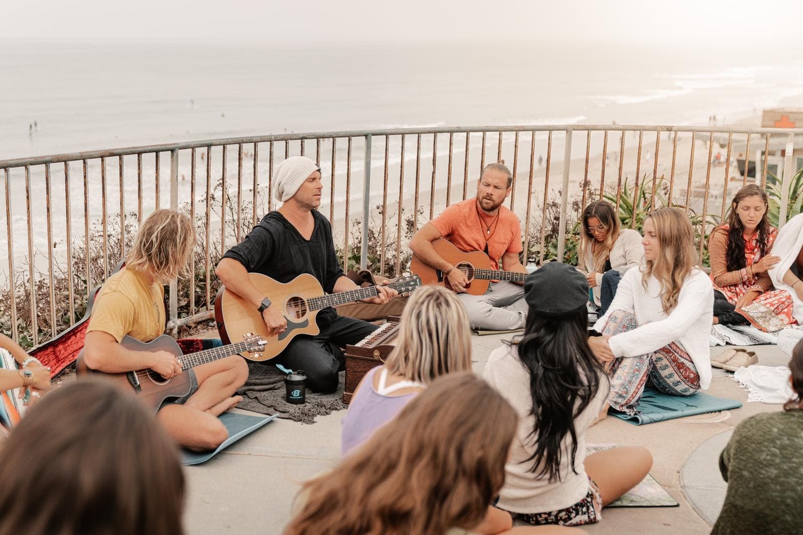 A group of people sitting in a circle singing together